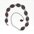 Silver oval concho chain belt with pink sunburst medallions and rope-edge engraving.