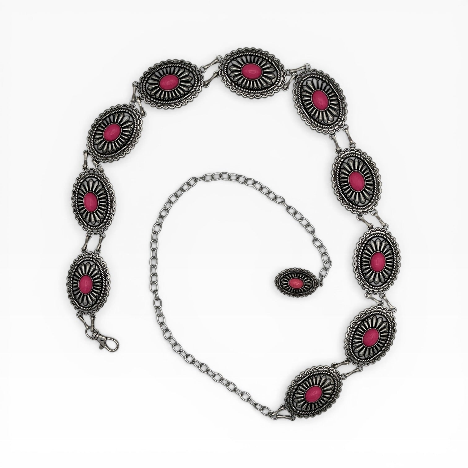Silver oval concho chain belt with pink sunburst medallions and rope-edge engraving.