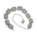 Silver chain belt with square rhinestone-studded conchos and beaded edges.