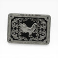Silver Rooster Midnight Buckle: Rectangular western buckle with a silver rooster on a black background, surrounded by scrollwork and a rope edge.