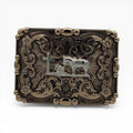 Antique gold buckle with silver kneeling cowboy, horse, and cross, framed by scrollwork, crystal flowers, and beaded border.
