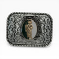 Two-tone silver oval buckle with gold San Judas Tadeo figure on a green and white background, surrounded by western scrollwork and a beaded border.