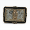 Gold and silver Virgen de Guadalupe buckle with black border, western scrollwork, and star accents.