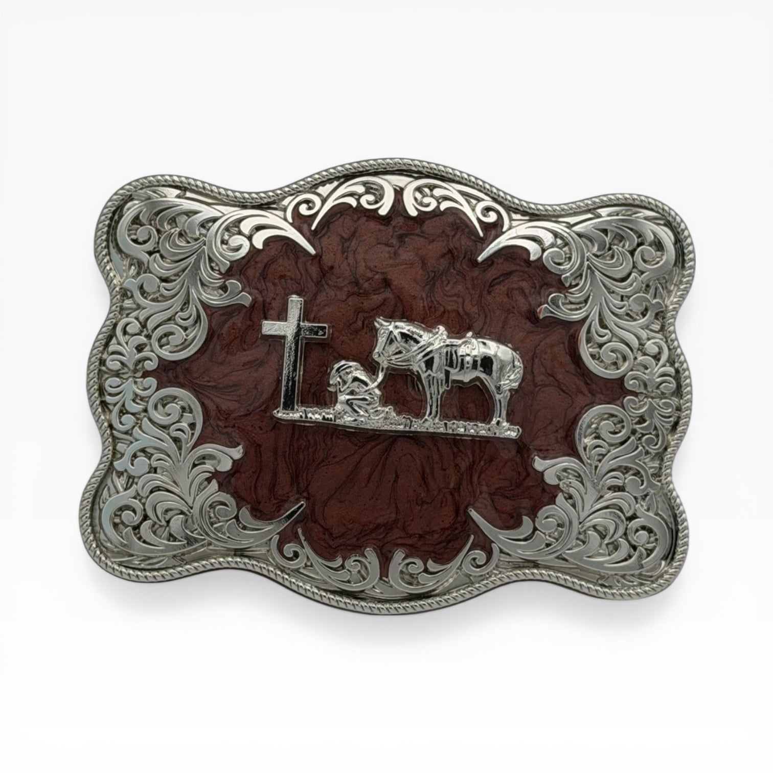 Mahogany wood-tone silver buckle with kneeling cowboy, horse, and cross, framed by ornate filigree and rope edge.