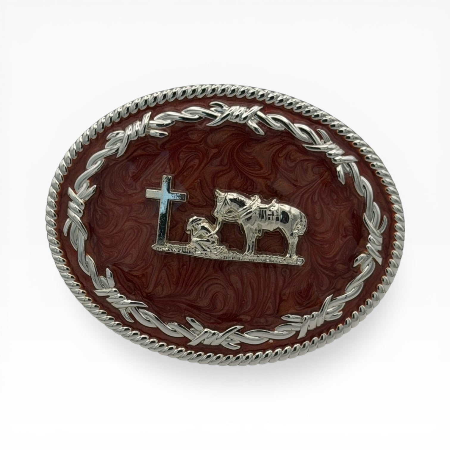 Mahogany oval buckle with silver kneeling cowboy, horse, cross, barbed wire, and rope edge.