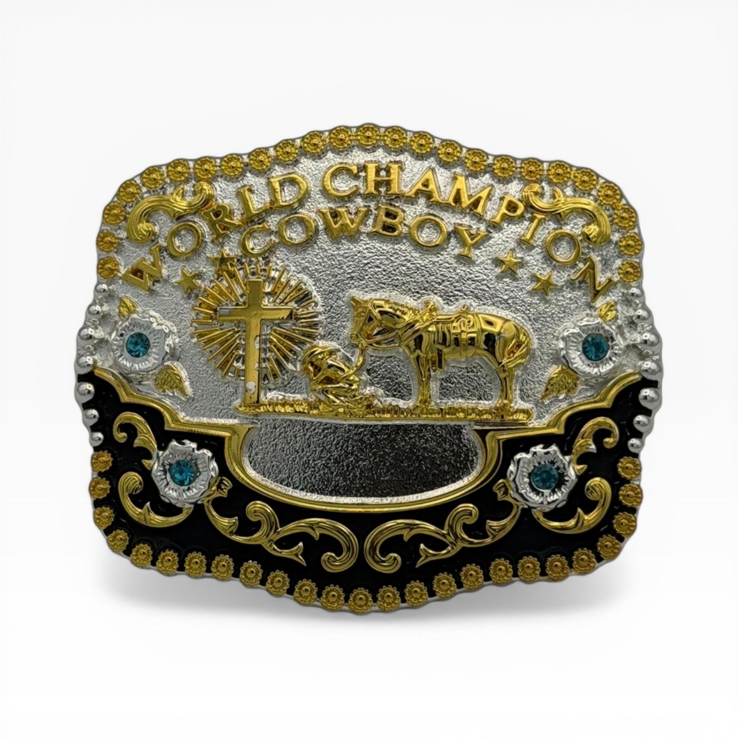 Gold and silver World Champion Cowboy buckle with kneeling cowboy, cross, horse, black enamel, and teal rhinestones.