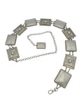 Silver Western metal concho belt with square, intricately engraved conchos and a chain closure.