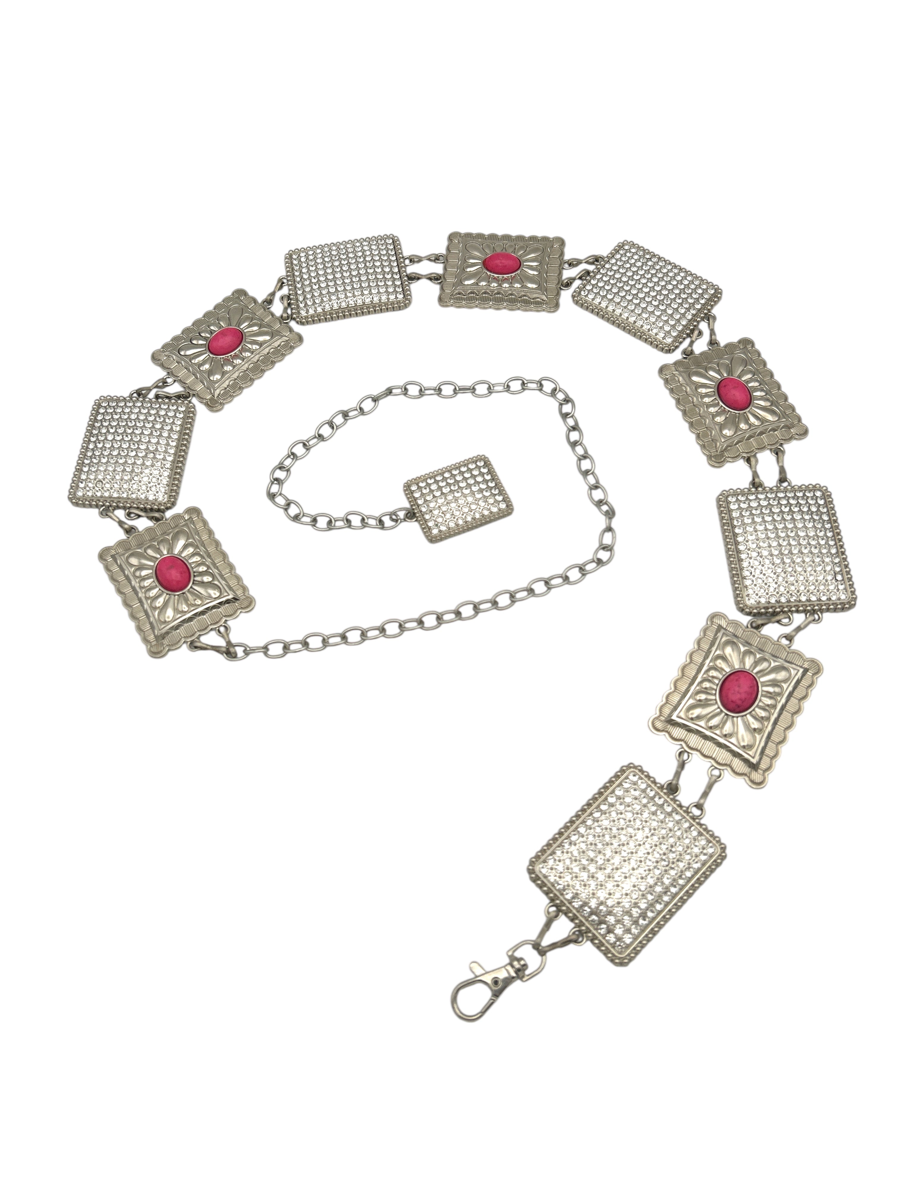 Silver Western metal concho belt with square, intricately engraved conchos and pink stones.