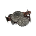 Tan floral embossed leather Ariat ladies belt with large oval silver conchos and buckle.
