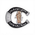 Copper San Judas horseshoe buckle with black enamel, silver engraved western scrolls.