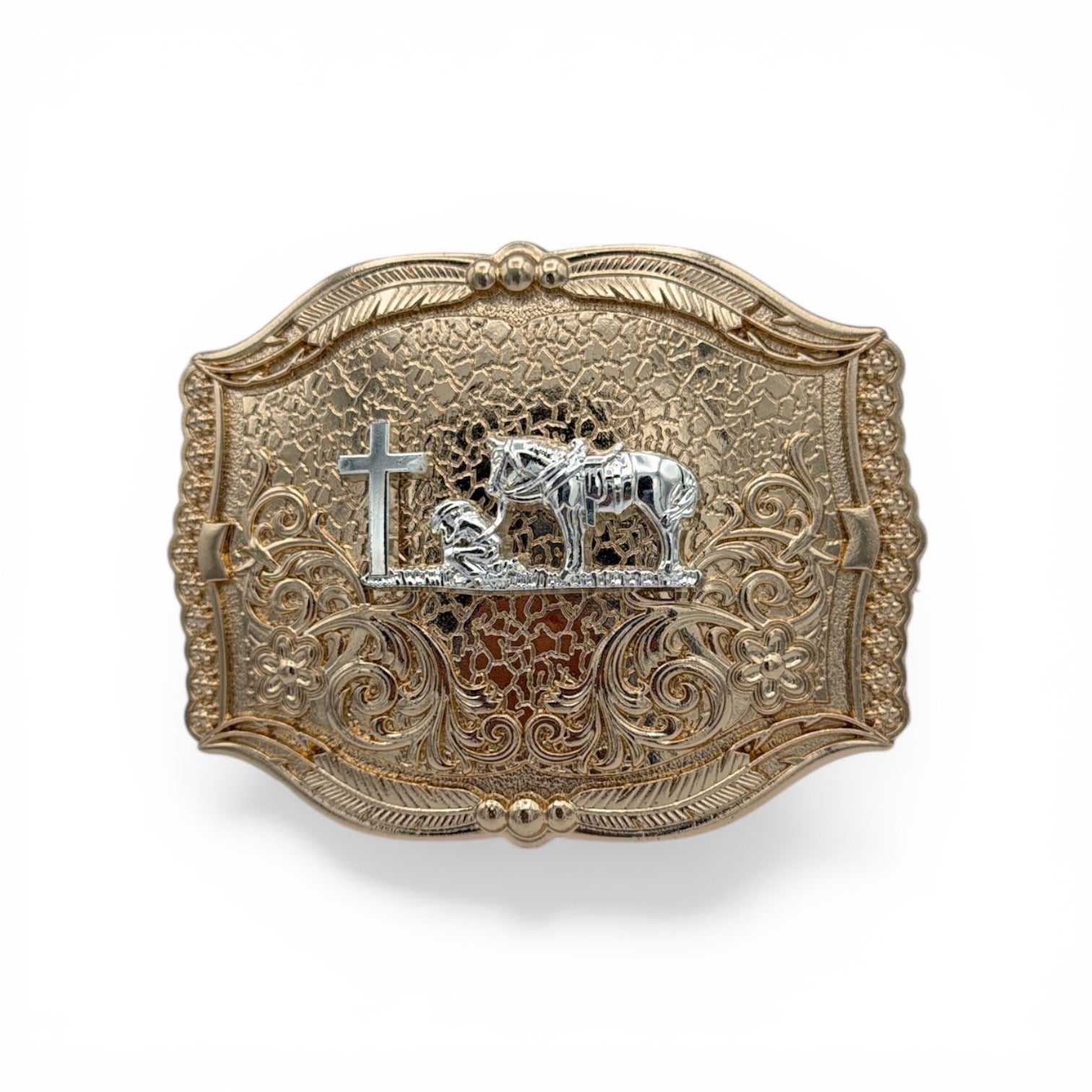 Gold and silver tone cowboy buckle with a kneeling cowboy, horse, and cross on an engraved western scroll background.