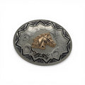 Oval two-tone metal buckle with a gold horse head, silver western scrollwork, and a black Aztec border.
